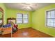 Bright bedroom with lime green walls and hardwood floors at 1778 Campbellton Sw Rd, Atlanta, GA 30311