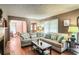 Spacious living room with hardwood floors, sectional sofa, and fireplace at 1778 Campbellton Sw Rd, Atlanta, GA 30311