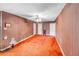 Large bedroom with orange carpet and striped wallpaper at 1778 Campbellton Sw Rd, Atlanta, GA 30311