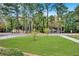 Large grassy front yard with mature trees and street view at 1778 Campbellton Sw Rd, Atlanta, GA 30311