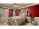 Bedroom with red walls, ceiling fan, and gray bed at 1594 Harbour Oaks Rd, Tucker, GA 30084