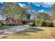 Brick ranch house with a carport and yard at 1594 Harbour Oaks Rd, Tucker, GA 30084