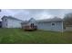 Gray house with wooden deck and fenced yard at 2073 Marbut Ln, Lithonia, GA 30058