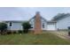 Gray house with brick chimney and attached garage at 2073 Marbut Ln, Lithonia, GA 30058