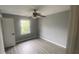 Gray-walled bedroom with gray vinyl flooring and ceiling fan at 2073 Marbut Ln, Lithonia, GA 30058