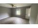 Gray-walled bedroom with gray vinyl flooring and ceiling fan at 2073 Marbut Ln, Lithonia, GA 30058