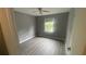 Gray-walled bedroom with gray vinyl flooring and ceiling fan at 2073 Marbut Ln, Lithonia, GA 30058