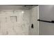 Clean shower with marble-look tile and modern fixtures at 2073 Marbut Ln, Lithonia, GA 30058