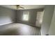 Spacious bedroom with grey walls and wood-look flooring at 2073 Marbut Ln, Lithonia, GA 30058