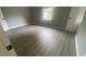 Spacious bedroom with grey walls and wood-look flooring at 2073 Marbut Ln, Lithonia, GA 30058