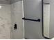 Clean shower with marble-look tile and modern fixtures at 2073 Marbut Ln, Lithonia, GA 30058