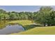 Golf course with pond and lush greenery at 98 De Arc Nw, Atlanta, GA 30327