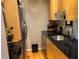 Galley kitchen with light wood cabinets and stainless steel appliances at 98 De Arc Nw, Atlanta, GA 30327