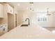 Kitchen island with white cabinets and quartz countertop, black faucet at 701 Trevett Way, Marietta, GA 30062