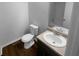 Clean bathroom with a toilet, sink and laminate flooring at 55 Faithful Dr, Temple, GA 30179