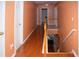 Upstairs hallway with hardwood floors and peach walls at 1376 Bramlett Forest Ct, Lawrenceville, GA 30045