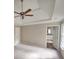 Main bedroom with tray ceiling, ceiling fan, and access to en-suite bathroom at 2654 Calumet Farm Ln, Snellville, GA 30039