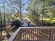 Deck overlooking wooded backyard with partial view of neighboring house at 2654 Calumet Farm Ln, Snellville, GA 30039
