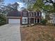 Brick two-story house with a large front yard and stamped concrete driveway at 2654 Calumet Farm Ln, Snellville, GA 30039