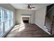 Gathering room with fireplace and hardwood floors, featuring abundant natural light at 2654 Calumet Farm Ln, Snellville, GA 30039