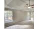 Spacious main bedroom with tray ceiling and ceiling fan at 2654 Calumet Farm Ln, Snellville, GA 30039