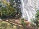 Side yard with mature trees and landscaping at 2654 Calumet Farm Ln, Snellville, GA 30039