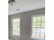 Bright bedroom with two large windows and neutral walls at 2654 Calumet Farm Ln, Snellville, GA 30039
