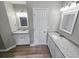 Double vanity bathroom with granite countertops and white cabinets at 2654 Calumet Farm Ln, Snellville, GA 30039