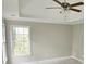 Spacious bedroom with large window and ceiling fan at 2654 Calumet Farm Ln, Snellville, GA 30039