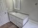 Bathroom with granite countertop, white cabinets and a bathtub at 2654 Calumet Farm Ln, Snellville, GA 30039