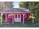 Red workshop with covered porch and bench at 4409 Shiloh Rd, Loganville, GA 30052