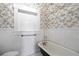 Classic bathroom with clawfoot tub and toile wallpaper at 4409 Shiloh Rd, Loganville, GA 30052