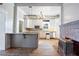 Open kitchen with island, wood floors, and a wood-burning stove at 4409 Shiloh Rd, Loganville, GA 30052