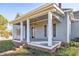 Inviting front porch with white columns and chandelier at 4409 Shiloh Rd, Loganville, GA 30052