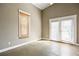 Bright bonus room with French doors and concrete floors at 4409 Shiloh Rd, Loganville, GA 30052