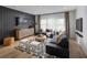 Finished basement with dark walls, a sectional sofa and large TV at 5063 Baywood Ln, Woodstock, GA 30188