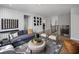 Bright bonus room with a sectional sofa and plenty of space for entertainment at 5063 Baywood Ln, Woodstock, GA 30188