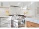 Stainless steel appliances and white shaker cabinets highlight this kitchen at 1646 Tichenor Ct, Dunwoody, GA 30338