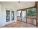 Relaxing screened porch with wooden deck and French doors at 65 Somersby Ln, Hiram, GA 30141