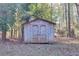 Wooden storage shed nestled in a wooded area at 10215 Alvin Rd, Alpharetta, GA 30022