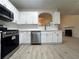 Modern kitchen with stainless steel appliances and white cabinets at 137 St Ann Cir, Dallas, GA 30157
