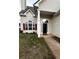 House entrance with black door and red shutters at 137 St Ann Cir, Dallas, GA 30157