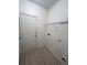 Laundry room with ample shelving and a white door at 137 St Ann Cir, Dallas, GA 30157