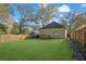 Large backyard with lush lawn, wooden fence, and deck at 1171 Oak Sw St, Atlanta, GA 30310