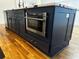 Stylish kitchen island with dark blue cabinetry and stainless steel appliances at 974 Coleman Sw St, Atlanta, GA 30310