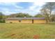 Back of the house showcasing a large yellow house with a sizable backyard at 1187 Dixie Rd, Covington, GA 30014