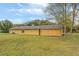 Back of the house showcasing a large yellow house with a sizable backyard at 1187 Dixie Rd, Covington, GA 30014