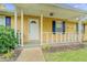 House exterior featuring a front porch and yellow siding at 1187 Dixie Rd, Covington, GA 30014