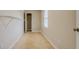 Laundry room with tile floor and ample shelving at 1187 Dixie Rd, Covington, GA 30014