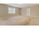 Spacious living room with neutral carpeting and walls at 1187 Dixie Rd, Covington, GA 30014